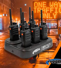 25 HANDHELD UHF RADIOS AND 4 BANK CHARGERS